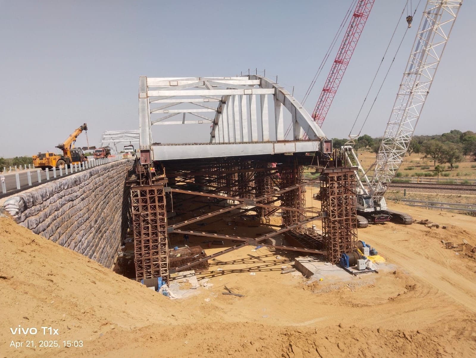 Block and panel walls for highways, landfills, and other retaining walls with Uniaxial Geogrid
