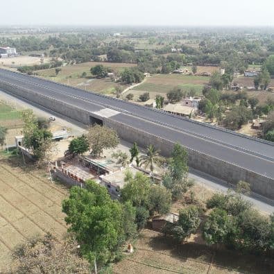 Block and panel walls for highways, landfills, and other retaining walls with Uniaxial Geogrid